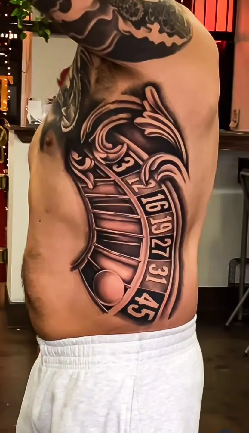 black and grey clock and numbers rib panel tattoo by Steve Bachman, Long Beach