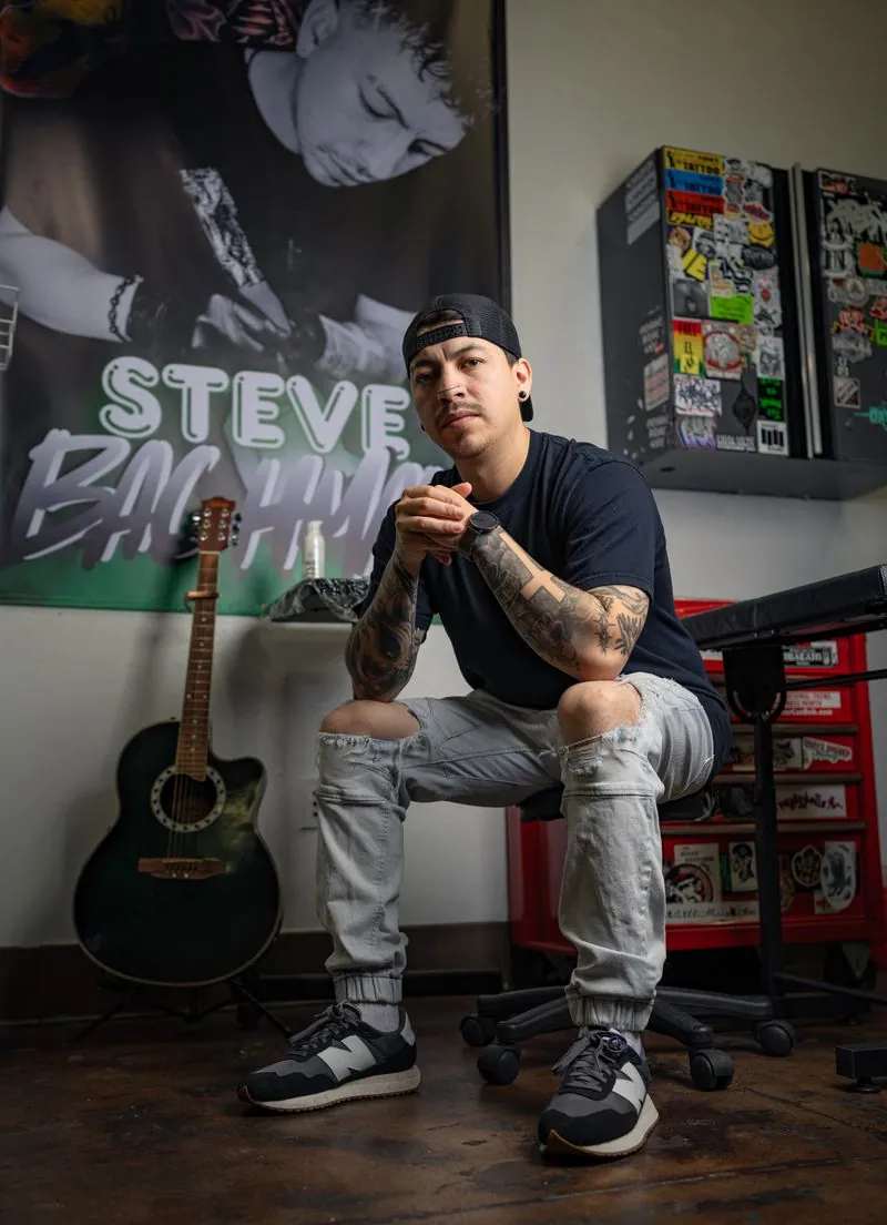 Steve Bachman tattooing at his station in Long Beach, California